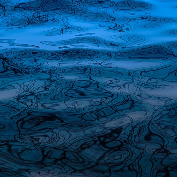 Abstract visual representing sound waves and rhythm in calm blue tones.