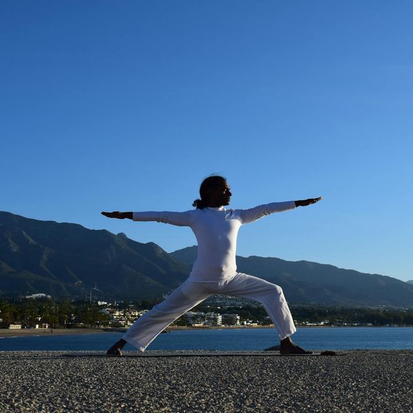 Person stretching gently outdoors at sunrise, embodying flexibility and peace.